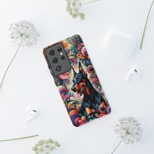 Vibrant Doberman phone case with a colorful artistic design surrounded by flowers and tech accessories.