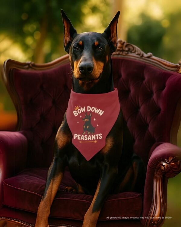 A sleek Doberman wearing this “Bow Down, Peasants” bandana, sitting like royalty on a velvet couch